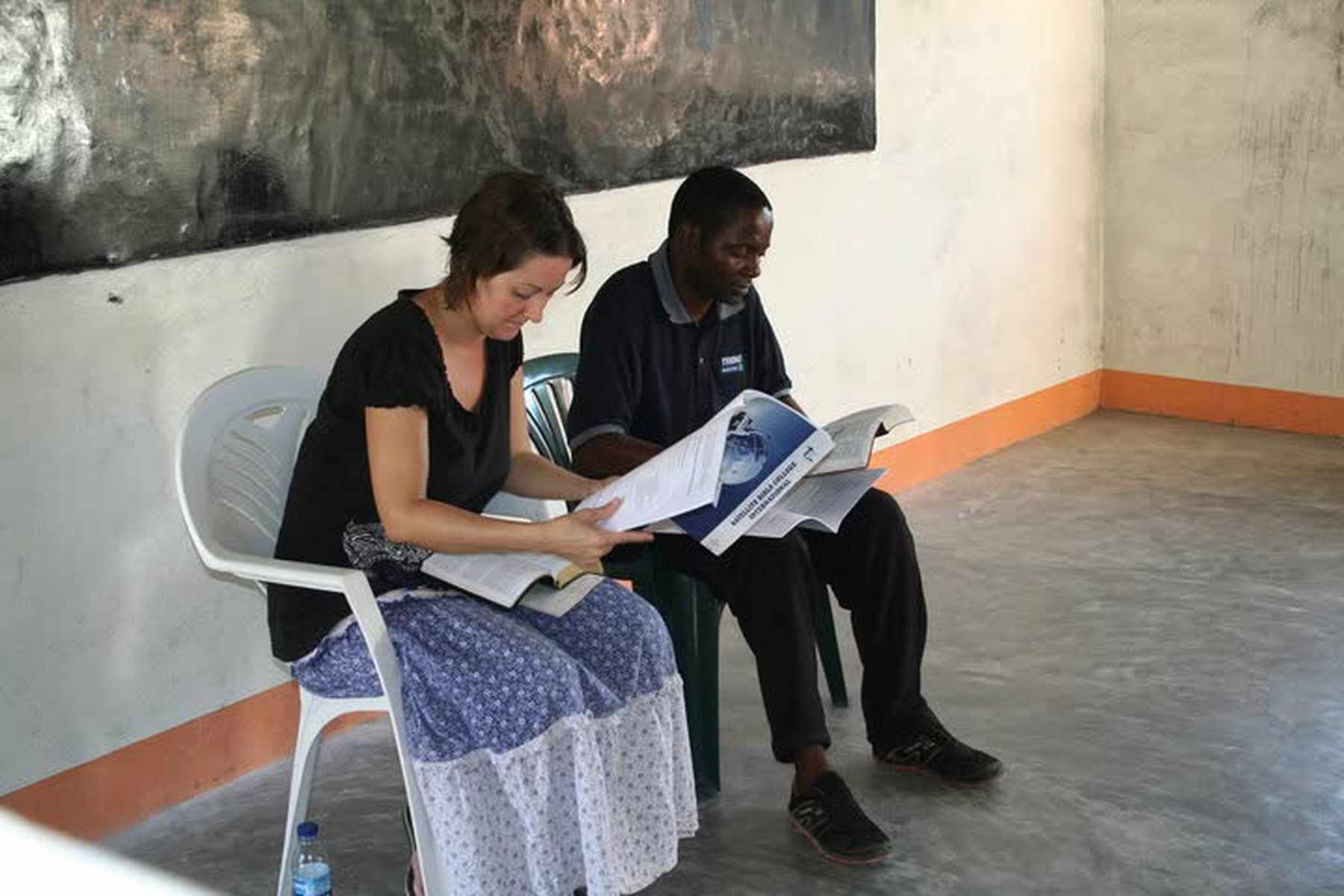 Susan teaching New Testament Survey, a foundational course, to first-year Bible school students in Dondo, Mozambique, in 2010, with Bible School Director Pastor Pascoal translating.