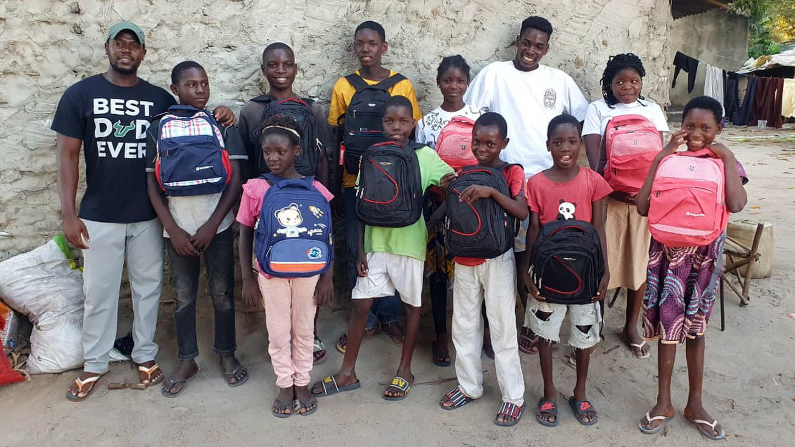 Orphaned and vulnerable children in Mozambique with new school backpacks