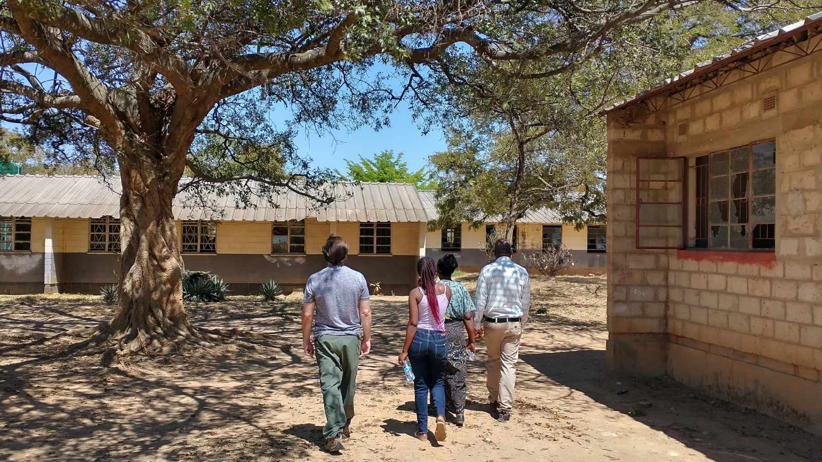 Walking together toward the classroom buildings of a boarding school in Zambia